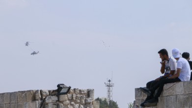 Turkish Air Force helicopters and fighter jets perform aerobatic maneuvers during Teknofest