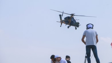Turkish Air Force helicopters and fighter jets perform aerobatic maneuvers during Teknofest