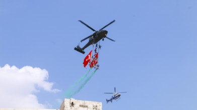 Türkiye special operations police hang from a helicopter with ropes, carrying weapons and unfurling