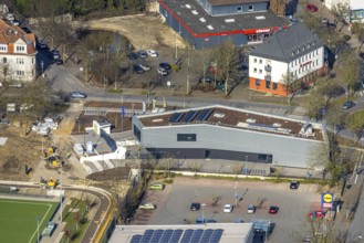 Aerial view, construction site and new sports building and integration building on the corner of