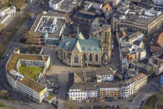 Aerial view, St. Urbanus Catholic Church and church square, commercial buildings and shopping