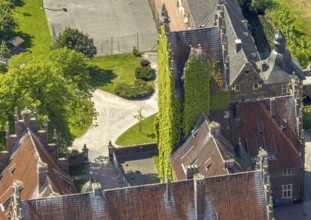 Aerial photo, storks and their nests on the roof of Heessen Castle, stork droppings on the roof,