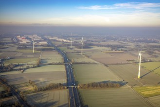 Aerial view, motorway A2, meadows and fields with wind turbines, distant view to the industrial