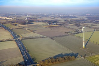Aerial view, motorway A2, meadows and fields with wind turbines, distant view to the industrial