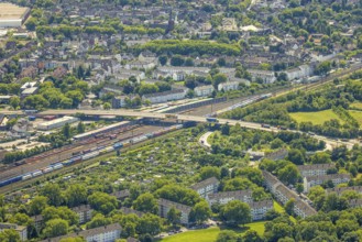 Aerial view, railway line with container site and bridge Friedrich-Ebert-Straße with curved road