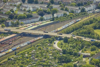 Aerial view, railway line with container site and bridge Friedrich-Ebert-Straße with curved road