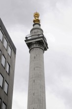 Corinthian Column in Warwick Court, London, Column with gold decorated top in front of clear blue