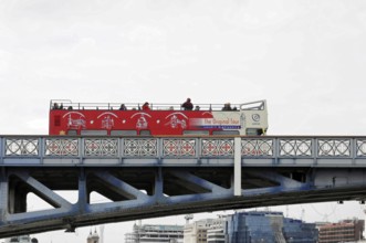 London, England, Great Britain, Europe, Red double-decker bus for city tours on a bridge