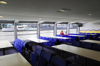 London, England, Great Britain, Europe, Interior of a boat with empty seats and view of the river