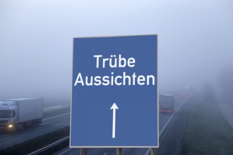 (Photomontage) Motorway sign with the inscription TRÜBE AUSSICHTEN above a foggy motorway