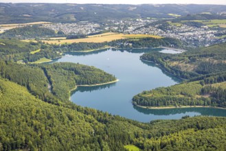 Aerial view, Hennesee dam surrounded by forest, Welcome Hotel and view to Meschede, sailing boat on