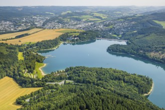 Aerial view, Hennesee dam surrounded by forest, Welcome Hotel and view to Meschede, sailing boat on