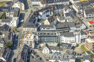 Aerial view, construction site with construction crane and new residential building on the corner