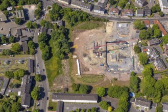 Aerial view, construction site and construction crane for residential complex Quartier der