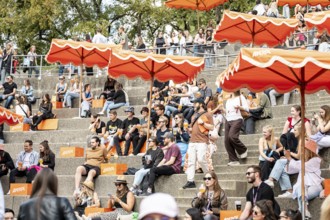 Visitors relax at the Aperol stand at the Superbloom Festival, Day 1 in the Olympic Park, Munich,