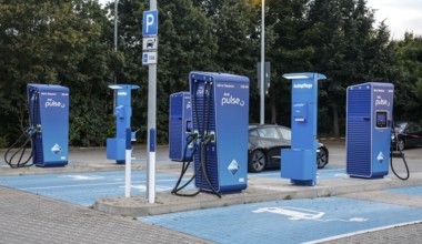 Charging stations with charging plugs at ARAl Pulse, Blankenfelde, 26/08/2025. A Tesla being