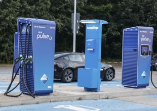 Charging stations with charging plugs at ARAl Pulse, Blankenfelde, 26/08/2025. A Tesla being