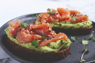 Breakfast, Sandwiches with smoked salmon and avocado, on dark rye bread, with microgreens, on a
