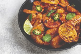 Grilled shrimp, unpeeled, headless, with spices, in a cast-iron skillet, homemade, no people