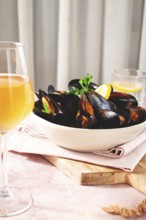 Boiled mussels, on a light table, with wine and lemon, homemade, no people