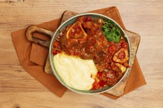 Ossobuco, stewed meat knuckle on the bone, with mashed potatoes, and oats and spices, homemade, no