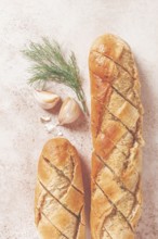Freshly baked garlic bread with herbs and garlic on a light countertop