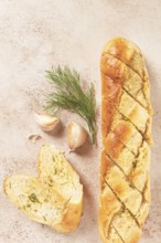 Freshly baked garlic bread with herbs and garlic on a light countertop