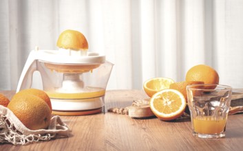 Preparation of freshly squeezed orange juice, using a juicer, in a cozy kitchen setting