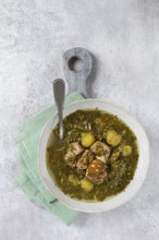 Chakapuli, Georgian dish, stewed meat with herbs and tkemali, in white wine, homemade, no people