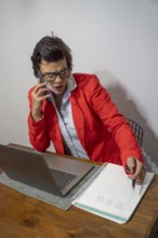 Focused businesswoman writing down important details from a call