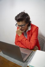Thoughtful businesswoman working from her home desk