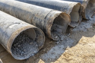 Old pipes with concrete residue in an open-cast mine, Manheim, North Rhine-Westphalia, Germany