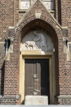 Church entrance with relief and locked door, Manheim, North Rhine-Westphalia, Germany