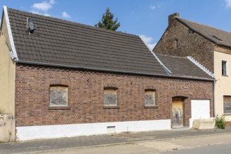 Brick house with barricaded windows and garage door, Manheim, North Rhine-Westphalia, Germany
