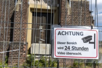 Warning sign Video surveillance in front of church behind fence, Manheim, North Rhine-Westphalia,