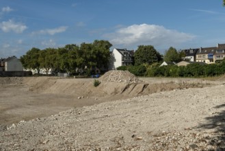Excavation pit with houses in the background, Ehrenfeld, Cologne, North Rhine-Westphalia, Germany