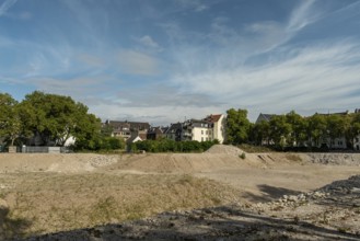 Excavation pit with houses in the background, Ehrenfeld, Cologne, North Rhine-Westphalia, Germany