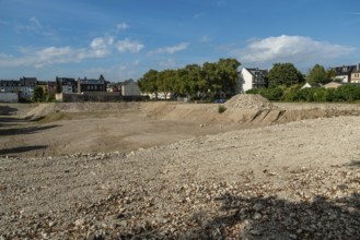 Excavation pit with houses in the background, Ehrenfeld, Cologne, North Rhine-Westphalia, Germany