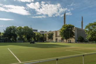 Football pitch with mosque in the background, Cologne, North Rhine-Westphalia, Germany