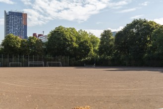Football pitch with tower block in the background