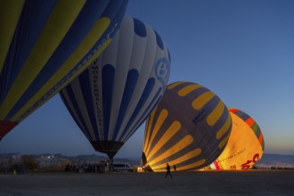Hot air balloons are illuminated at night while the sky in the background is dark, Göreme National