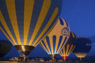 Hot air balloons glow in the dark with colourful lights, Göreme National Park, Göreme Tarihî Millî
