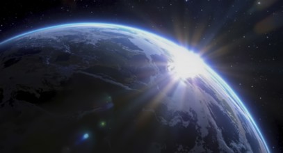 The sun rises over earth, illuminating the planet from space with a bright glow, surrounded by