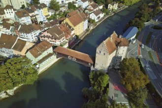 View of the old town with the river Limmat and the covered wooden bridge with the