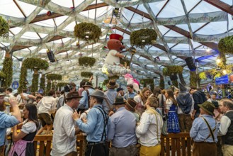 Visitors in the Hofbräu marquee at the Oktoberfest 2024 in Munich, Bavaria, Germany