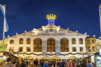 The Hofbräu marquee at Oktoberfest 2024 at dusk, Munich, Bavaria, Germany