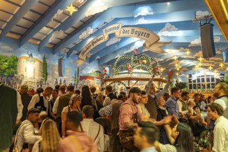 Visitors in the Hacker Pschorr marquee at the Oktoberfest 2024 in Munich, Bavaria, Germany