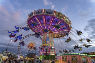 Chain carousel at Oktoberfest 2024 at dusk, Munich, Bavaria, Germany