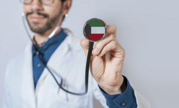 Doctor holding stethoscope with Kuwait flag. Kuwait health and care concept, Kuwait flag on