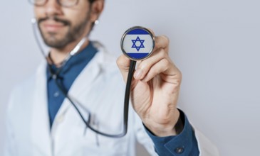 Doctor holding stethoscope with Israel flag. Israel health and care concept, Israel flag on